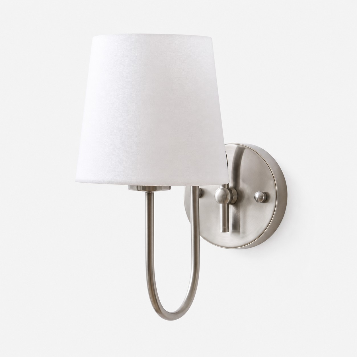 White shade satin nickel French style wall sconce on clean background