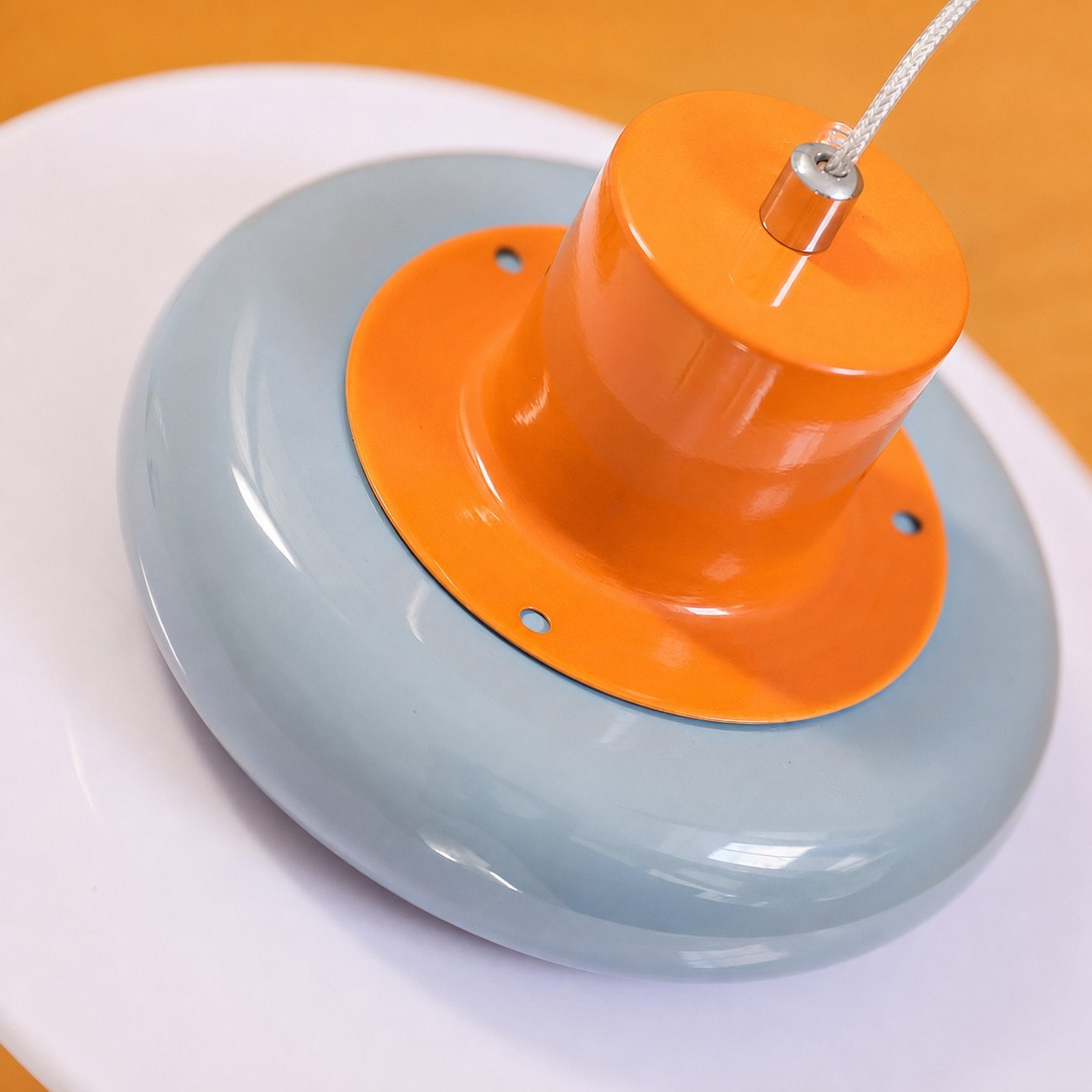 Close-up of glossy orange top and sea salt blue shade detail
